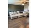 Spacious living room with a large comfortable sectional, ceiling fan, and laminate flooring at 2935 Flintwood Dr, Columbus, IN 47203