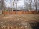 Spacious backyard with a wooden fence, offering privacy and room for recreation at 3008 W Grace Ln, Muncie, IN 47304
