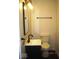 Bathroom with dark vanity, black faucet, mirror and toilet at 3008 W Grace Ln, Muncie, IN 47304