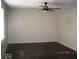 Clean bedroom featuring hardwood floors, ceiling fan, and a large window at 3008 W Grace Ln, Muncie, IN 47304