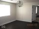 Bedroom with a large window and modern chandelier at 3008 W Grace Ln, Muncie, IN 47304
