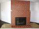 Large brick fireplace with dark hearth and black grate at 3008 W Grace Ln, Muncie, IN 47304