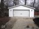 Detached white garage with a two-car garage door and decorative black hardware at 3008 W Grace Ln, Muncie, IN 47304