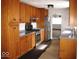 Well lit kitchen with wood cabinets, stainless steel appliances, and grey countertops at 3008 W Grace Ln, Muncie, IN 47304