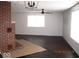 Spacious living room with large windows, ceiling fan and brick fireplace at 3008 W Grace Ln, Muncie, IN 47304