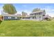 Large backyard featuring a well-maintained lawn, garage, home, and sunroom at 315 W High St, Pendleton, IN 46064
