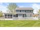 Backyard featuring home, garage, sunroom, and white picket fence at 315 W High St, Pendleton, IN 46064