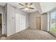 Bedroom featuring carpeted floors, neutral walls, ceiling fan, and natural light, with closets for storage at 315 W High St, Pendleton, IN 46064