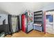 Bedroom with comic book decor, bright red door, window with dark curtains, and custom shelving at 315 W High St, Pendleton, IN 46064