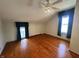 This bedroom has hardwood floors, angled ceilings, and windows for natural light at 315 W High St, Pendleton, IN 46064