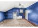 Bright bedroom with unique blue walls, carpet, windows with blinds, and a ceiling fan for comfort at 315 W High St, Pendleton, IN 46064