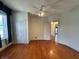 This bedroom features hardwood floors, a ceiling fan, and access to an adjoining room at 315 W High St, Pendleton, IN 46064