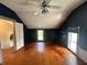 Bedroom featuring hardwood floors, dark walls, and natural light from the windows at 315 W High St, Pendleton, IN 46064