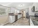 Full kitchen with tile flooring, white cabinets, and stainless steel appliances at 315 W High St, Pendleton, IN 46064