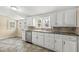 Bright kitchen featuring white cabinets, stainless steel dishwasher and stone tile backsplash at 315 W High St, Pendleton, IN 46064