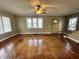 Spacious living room with hardwood floors, large windows, and a classic ceiling fan at 315 W High St, Pendleton, IN 46064