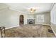 Spacious living room featuring a decorative fireplace, carpet flooring, and natural light, perfect for relaxation at 315 W High St, Pendleton, IN 46064