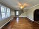 Open-concept living room features hardwood floors, staircase, and natural light at 315 W High St, Pendleton, IN 46064