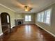Bright living room with fireplace, hardwood floors, and multiple windows at 315 W High St, Pendleton, IN 46064