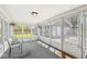 Bright sunroom featuring multiple windows, carpet flooring, and access to the backyard at 315 W High St, Pendleton, IN 46064