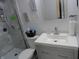 Sleek bathroom with a glass-door shower, toilet, and modern vanity with a countertop sink and framed wall art at 3426 Ireland Dr, Indianapolis, IN 46235