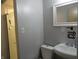 Cozy bathroom featuring a well-lit mirror, clean sink, and classic toilet at 3426 Ireland Dr, Indianapolis, IN 46235
