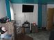 This bedroom showcases a mounted TV, a mini-fridge, and stylish decor, creating a comfortable space at 3426 Ireland Dr, Indianapolis, IN 46235