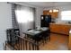 Bright eat-in kitchen with dining table and black appliances at 3426 Ireland Dr, Indianapolis, IN 46235