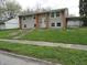 Split-level home with a brick facade, neutral siding, and a well-maintained front yard at 3426 Ireland Dr, Indianapolis, IN 46235