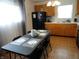 Eat-in kitchen with wood cabinets, a black refrigerator, and wood-look floors at 3426 Ireland Dr, Indianapolis, IN 46235