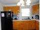 Kitchen with wood cabinetry, and black appliances at 3426 Ireland Dr, Indianapolis, IN 46235
