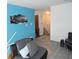 Open-concept living area with gray tile flooring, blue accent wall, and stairway at 3426 Ireland Dr, Indianapolis, IN 46235