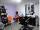 Salon featuring orange styling chairs, styling station and shelving at 3426 Ireland Dr, Indianapolis, IN 46235