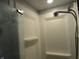 Modern shower featuring a shower head and built in shelves at 3426 Ireland Dr, Indianapolis, IN 46235