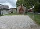 A spacious gravel backyard enclosed by a chain link fence provides ample parking or outdoor recreation space at 357 N 18Th Ave, Beech Grove, IN 46107