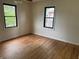 Sunlit bedroom with refinished hardwood flooring and black-trimmed windows at 357 N 18Th Ave, Beech Grove, IN 46107