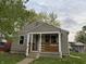 Charming single-story home with covered front porch and neutral siding at 357 N 18Th Ave, Beech Grove, IN 46107