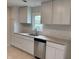 Bright kitchen with white cabinetry, stainless steel dishwasher, and granite countertops at 357 N 18Th Ave, Beech Grove, IN 46107