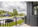 A charming balcony view from a stylish home with a black railing overlooks a quiet residential street at 401 Jersey St, Westfield, IN 46074