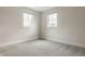 Bright, empty bedroom featuring neutral walls, carpet, white trim, and two windows that provide an abundance of natural light at 401 Jersey St, Westfield, IN 46074