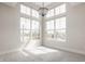 Bright bedroom featuring large windows with a modern chandelier and plush carpeting at 401 Jersey St, Westfield, IN 46074