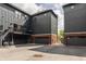 Exterior view showcasing modern townhomes with black siding, brick accents, garages, and small balconies with string lights at 401 Jersey St, Westfield, IN 46074