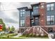 Modern townhome with red brick, gray siding, multiple windows, and landscaped front yard at 401 Jersey St, Westfield, IN 46074