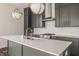 Kitchen island featuring gray cabinetry, quartz countertop, and stainless steel appliances at 401 Jersey St, Westfield, IN 46074