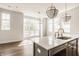 Sunlit kitchen island featuring stainless steel appliances and modern pendant lights at 401 Jersey St, Westfield, IN 46074