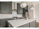 Modern kitchen with gray cabinets, stainless steel appliances, and sleek pendant lighting at 401 Jersey St, Westfield, IN 46074