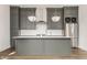 Modern kitchen featuring gray cabinets, stainless steel appliances, and a large island at 401 Jersey St, Westfield, IN 46074