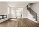 Bright open-concept living room with fireplace and staircase showcasing modern design at 401 Jersey St, Westfield, IN 46074