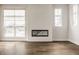Bright living room with modern fireplace, wood flooring, and lots of natural light at 401 Jersey St, Westfield, IN 46074
