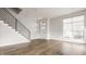 Bright, open-concept living area featuring modern staircase, wood floors, and ample natural light at 401 Jersey St, Westfield, IN 46074